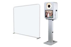 A photo booth with a backdrop and stand.